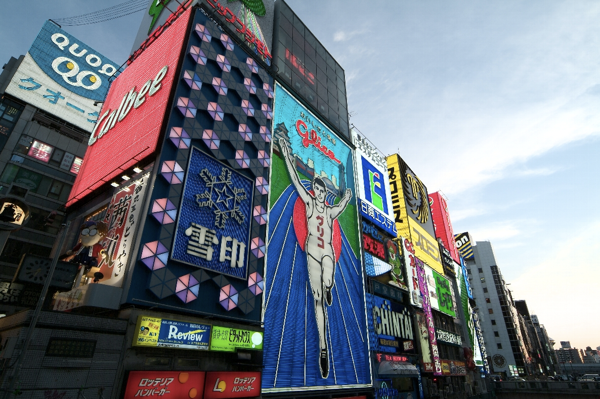 Iconic Glico Man billboard and vibrant neon signs in Dotonbori, Osaka